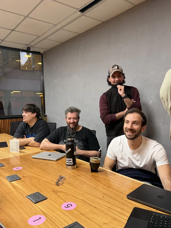 The same meeting a moment later, the table mid-conversation
