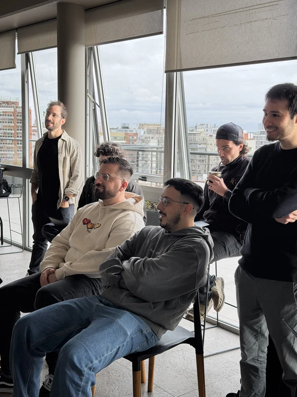 Colleagues talking in a lounge by floor-to-ceiling windows over the city