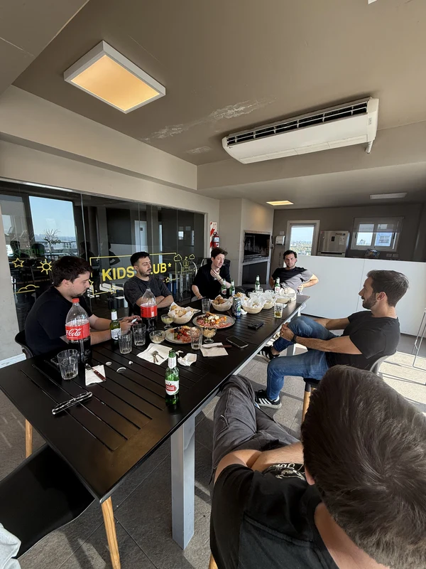 The team around a long table set with food and drinks